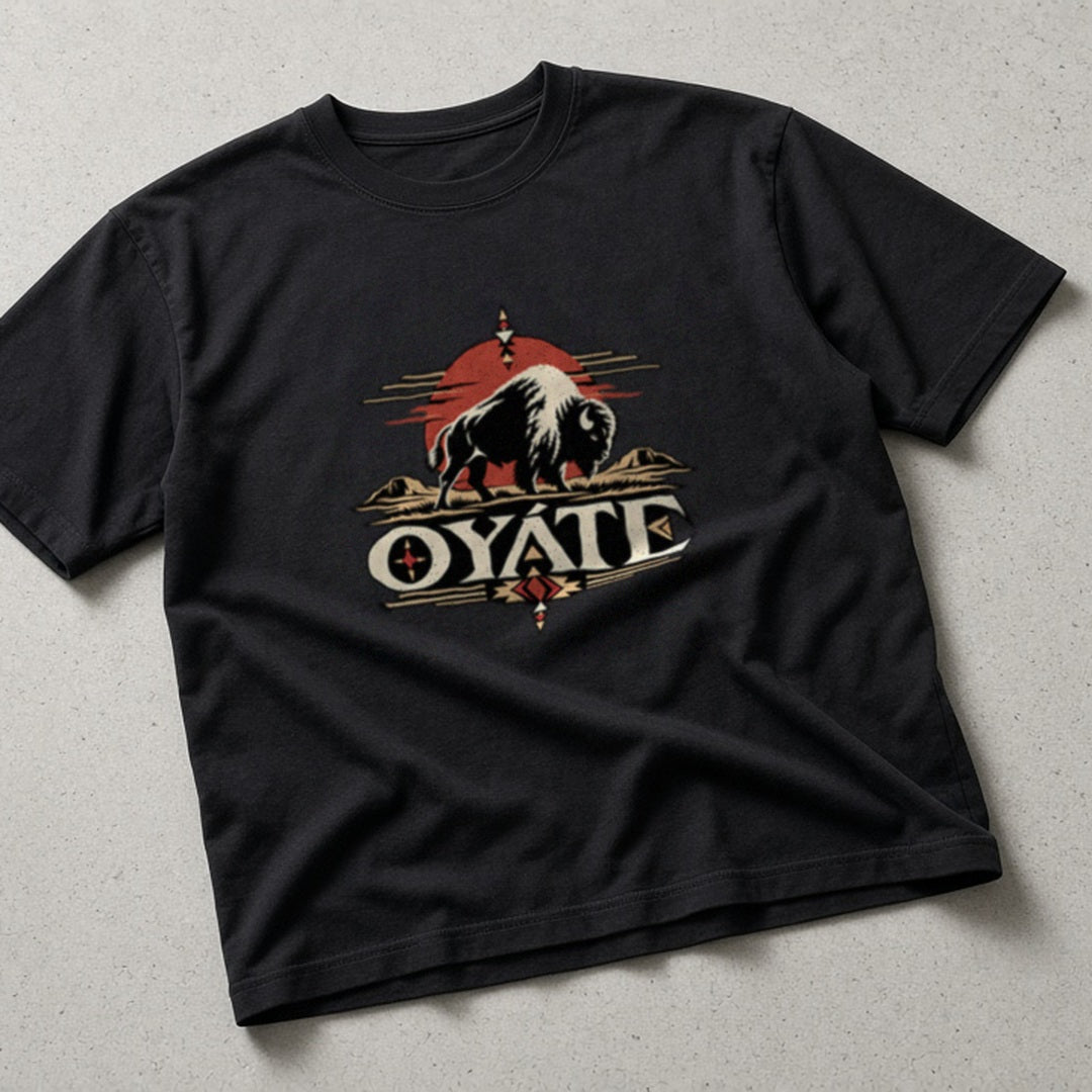 OYÁTE Dark Buffalo v2 Premium Tee, flat lay on concrete